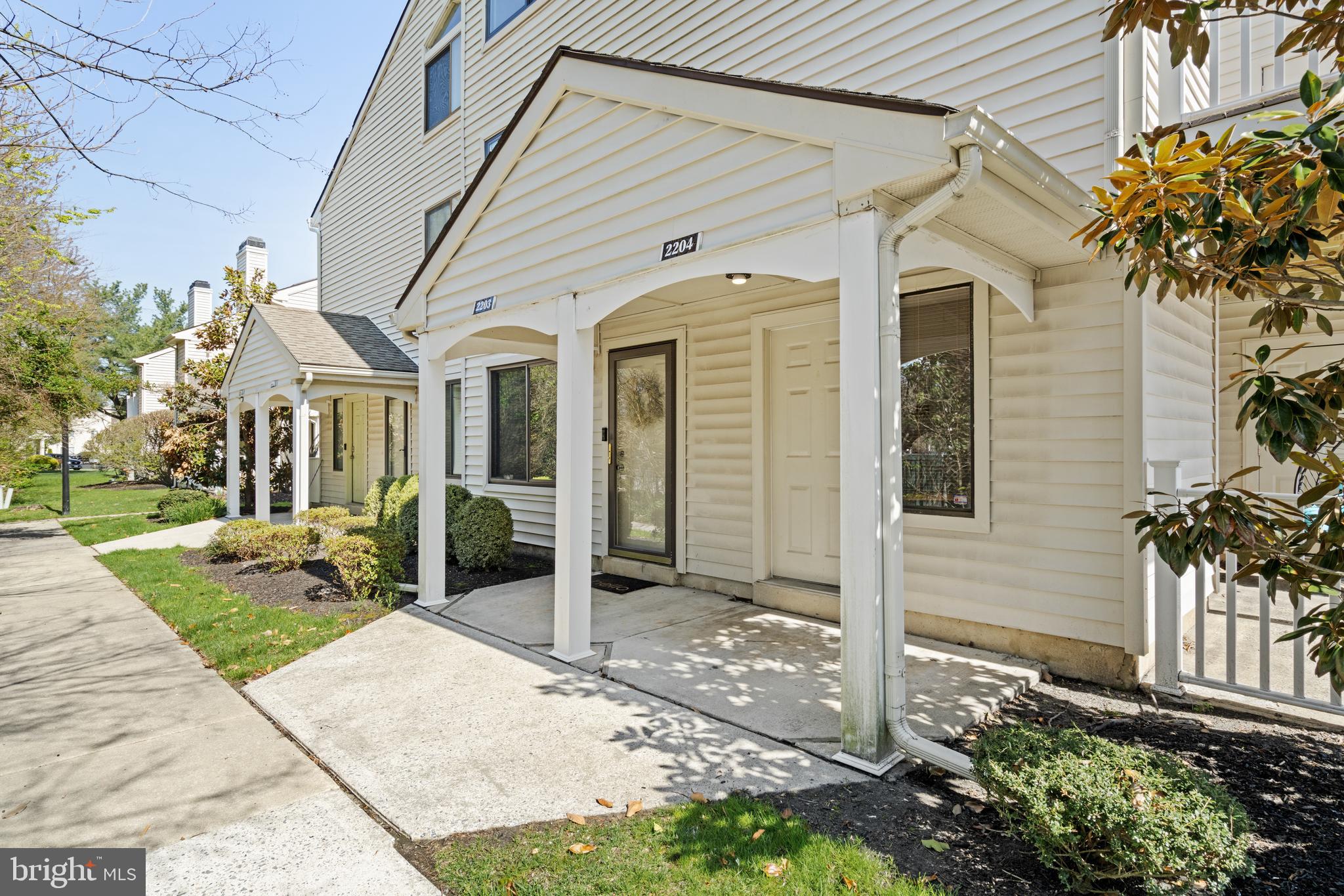 a front view of a house with a garden and plants