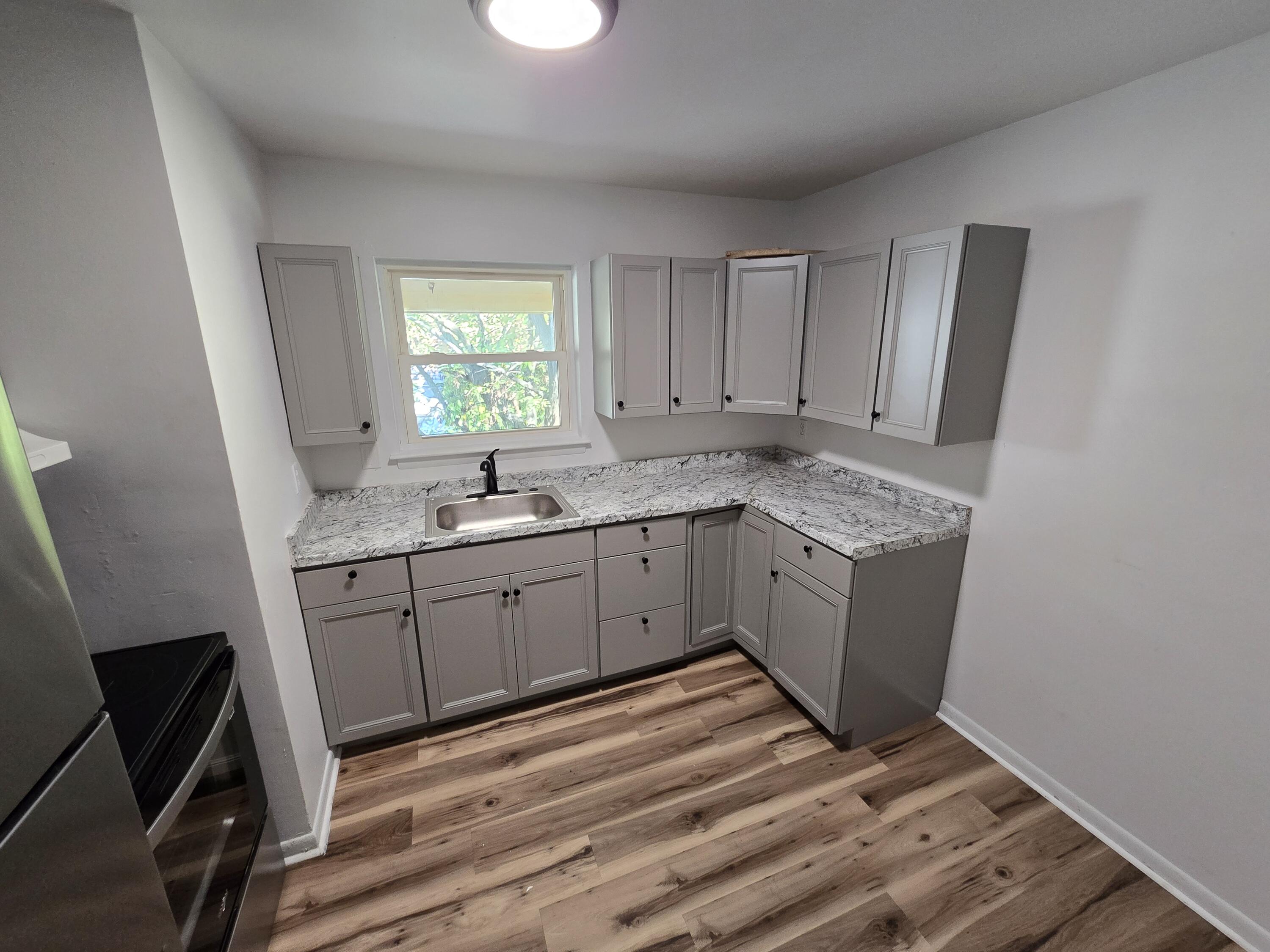 2607 Westover Avenue Southwest, Unit 207 Roanoke, VA 24015 - Photo 3 of 7 a kitchen with a sink window and cabinets