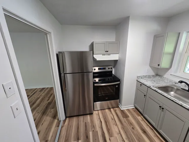 a kitchen with a refrigerator and a sink