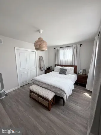 a spacious bedroom with a bed and a chandelier