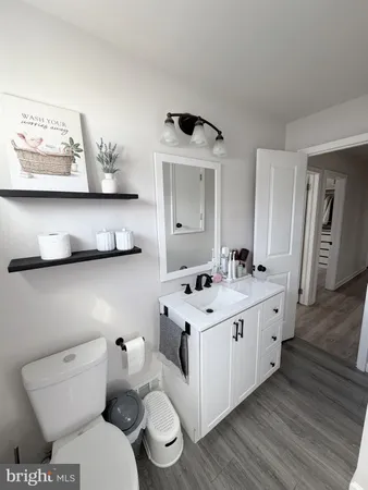 a bathroom with a toilet sink and mirror