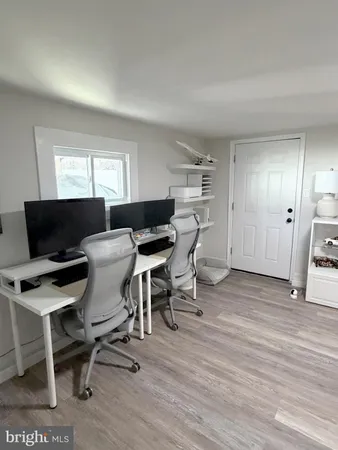 a living room with furniture a flat screen tv and a window