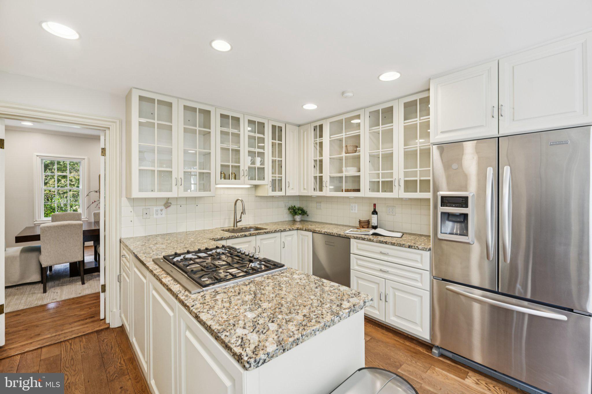 1545 35th Street Northwest Washington, DC 20007 - Photo 19 of 65 a kitchen with stainless steel appliances granite countertop a stove refrigerator and sink