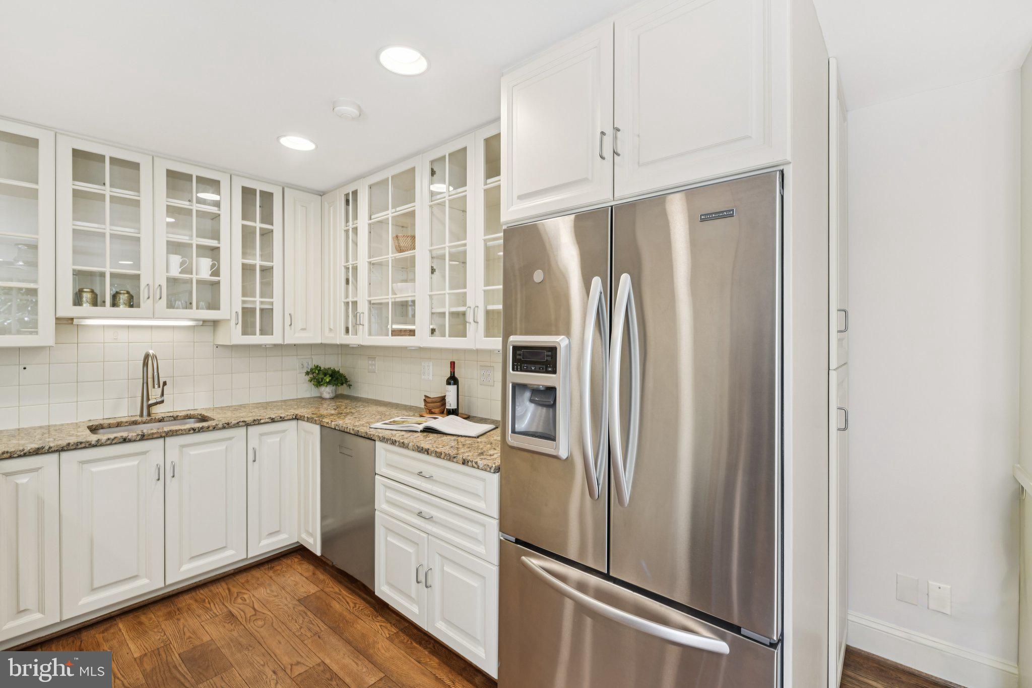 1545 35th Street Northwest Washington, DC 20007 - Photo 25 of 65 a kitchen with a sink a refrigerator and cabinets
