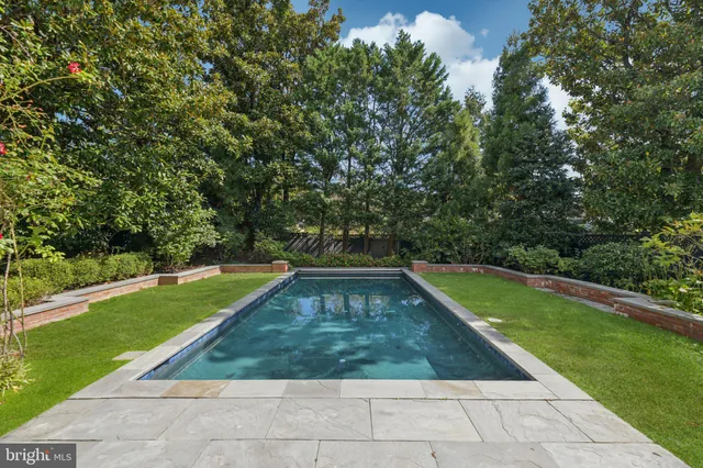 a front view of a house with swimming pool and porch