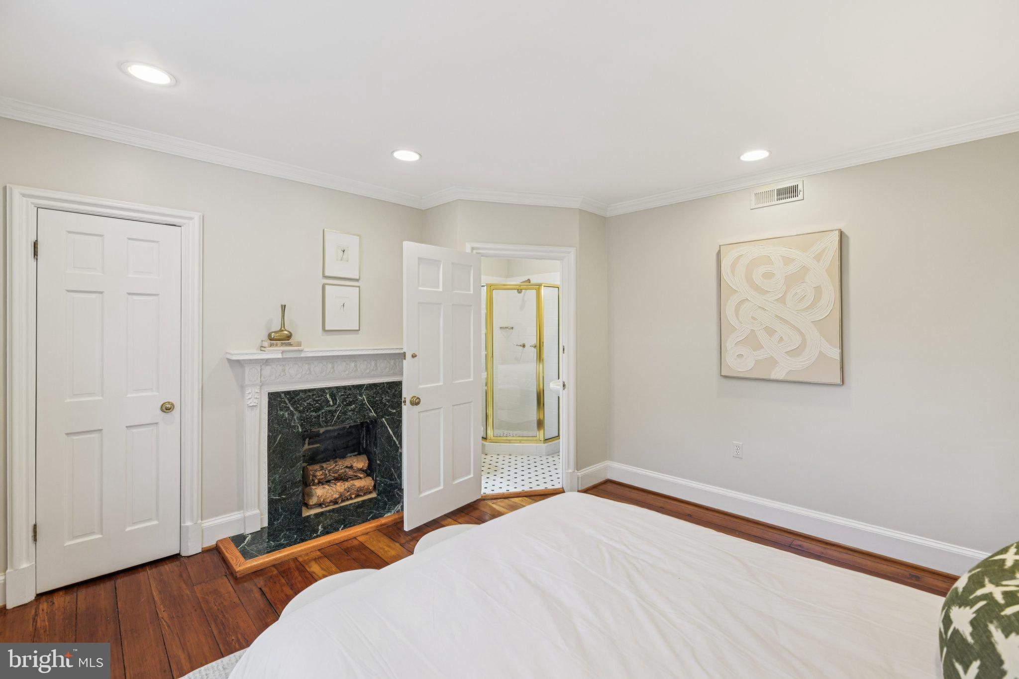 1545 35th Street Northwest Washington, DC 20007 - Photo 43 of 65 a bedroom with a bed and a fireplace