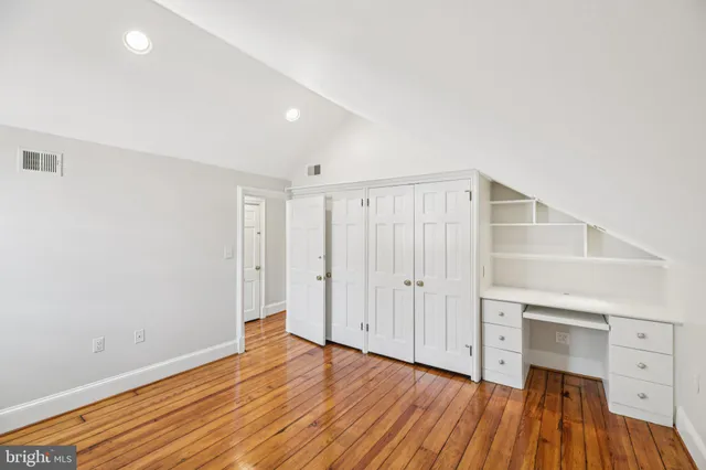 a bathroom with a shower sink vanity and toilet