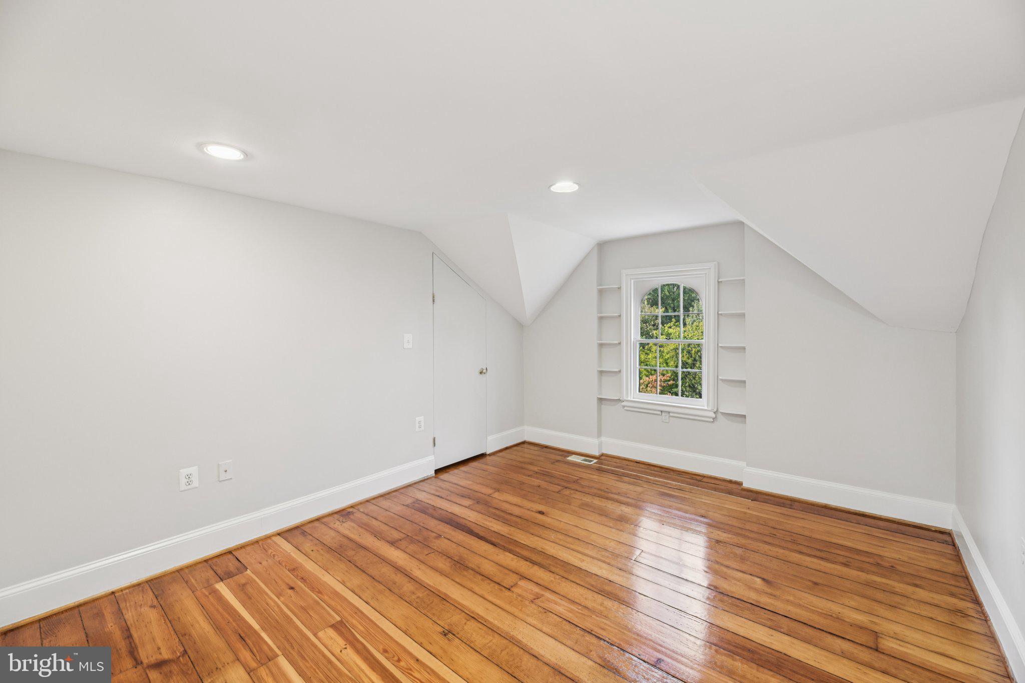 1545 35th Street Northwest Washington, DC 20007 - Photo 50 of 65 an empty room with wooden floor and windows