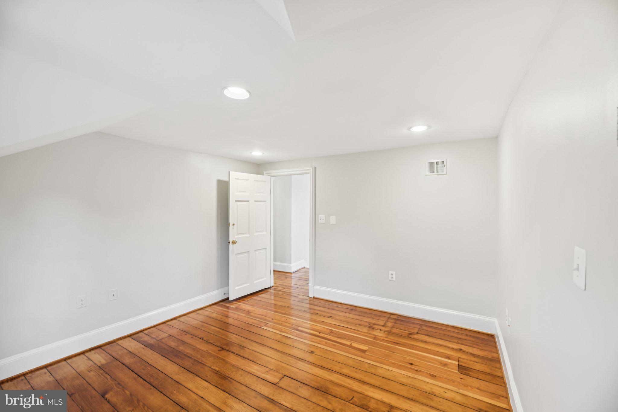 1545 35th Street Northwest Washington, DC 20007 - Photo 52 of 65 a view of an empty room with wooden floor