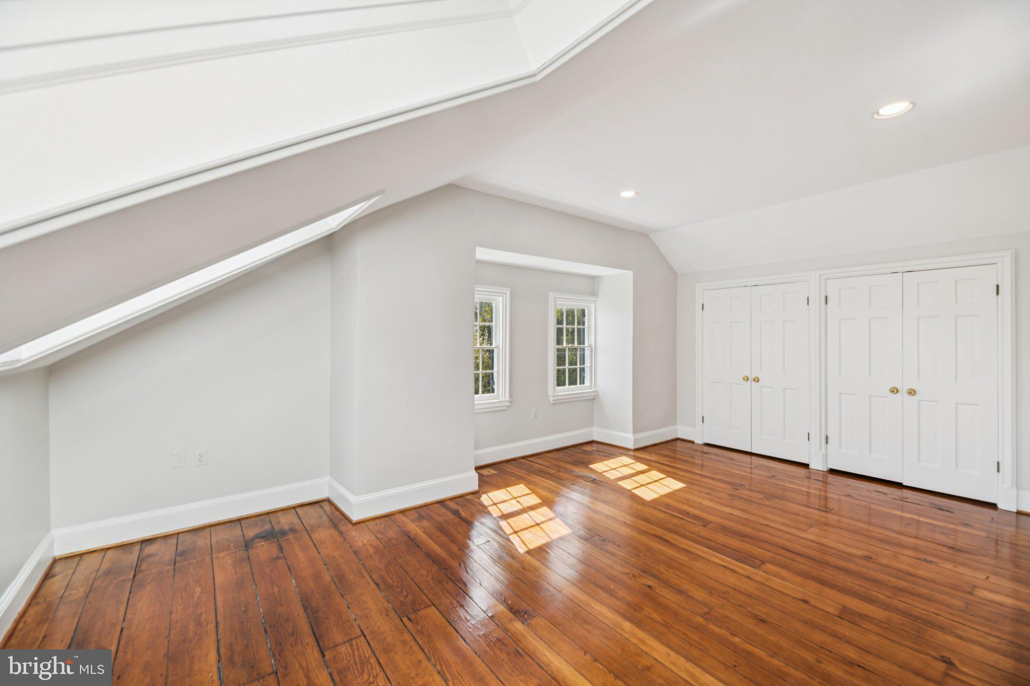 1545 35th Street Northwest Washington, DC 20007 - Photo 56 of 65 a view of an empty room with wooden floor and a window