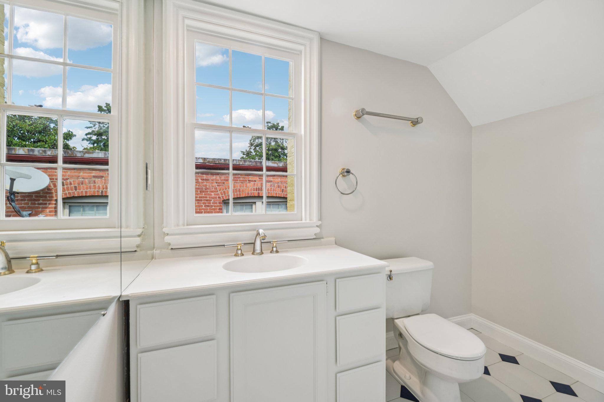 1545 35th Street Northwest Washington, DC 20007 - Photo 58 of 65 a bathroom with a toilet sink and mirror