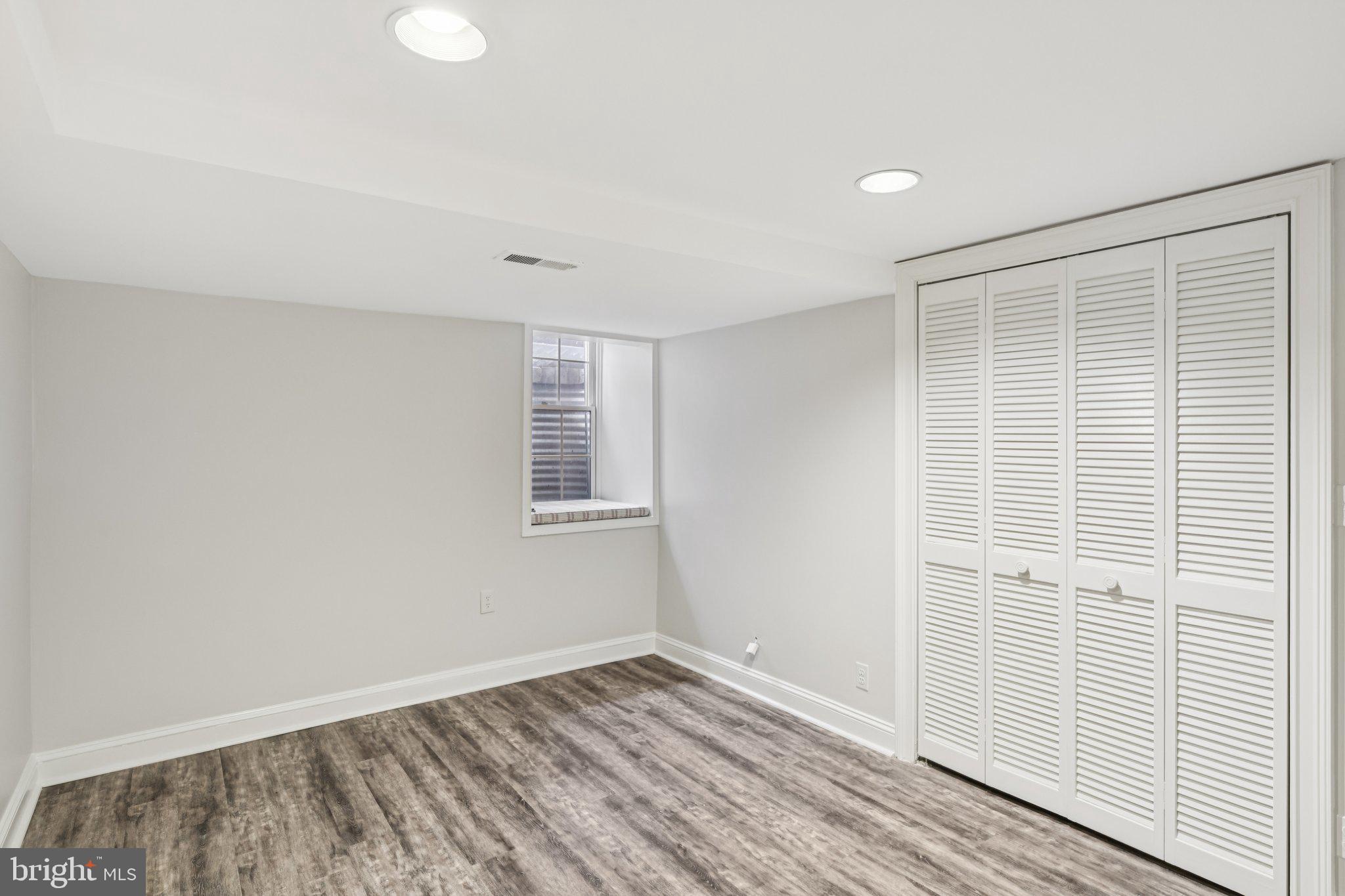 1545 35th Street Northwest Washington, DC 20007 - Photo 61 of 65 an empty room with wooden floor and windows