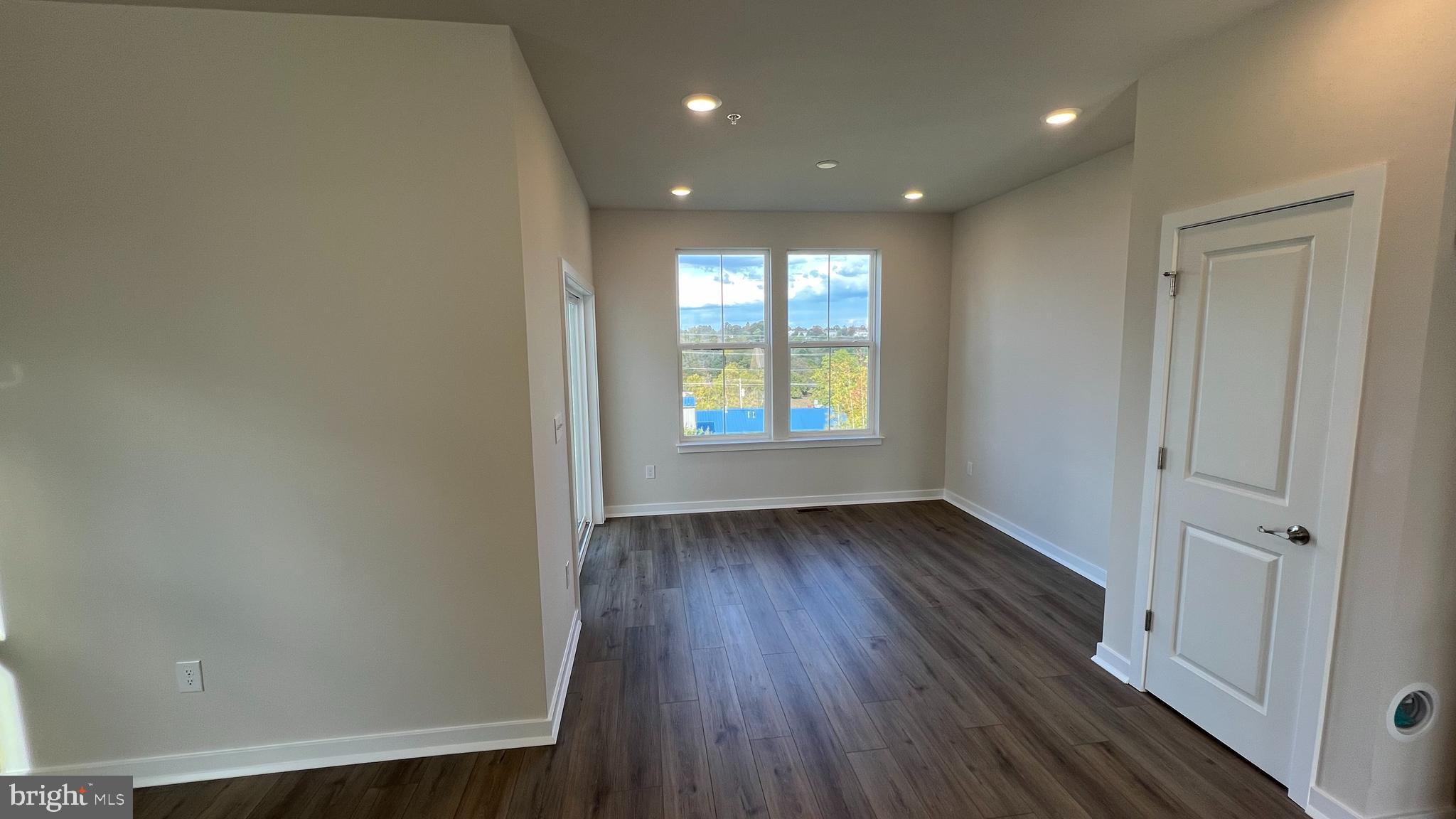 839 Pecan Road Spring City, PA 19475 - Photo 7 of 25 a view of an empty room with wooden floor and a window