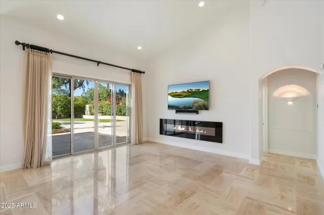 a view of a hallway with a chandelier fan and wooden floor