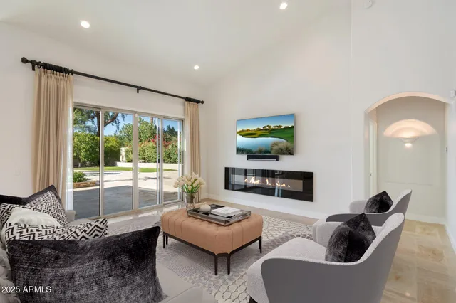 a view of a livingroom with a furniture and floor to ceiling window