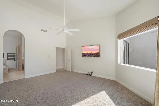 a bedroom with a large bed and a window