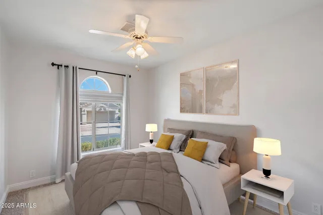 an empty room with windows and fan