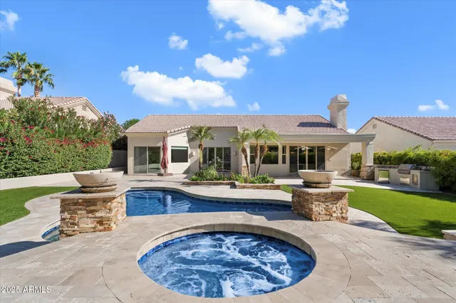 a view of a house with swimming pool and sitting area