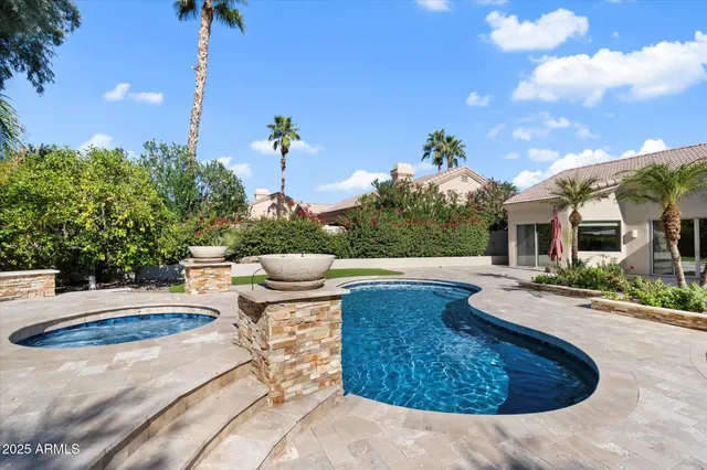 a view of a house with swimming pool and furniture