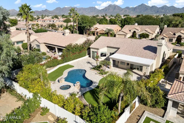 an aerial view of a house with outdoor space and sitting space