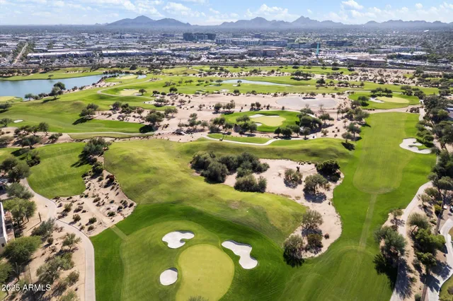 an aerial view of residential houses with outdoor space and parking