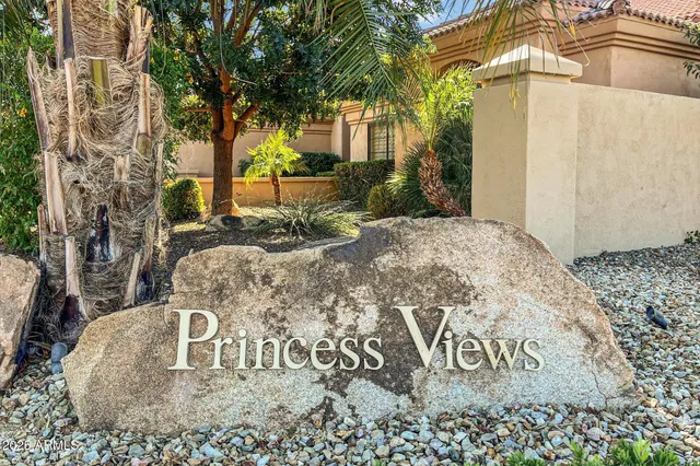 a street sign that is sitting in front of flowers