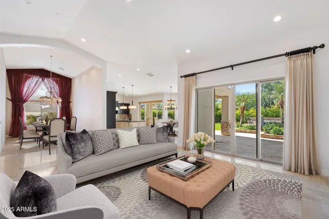 a view of a hallway with dining area and chandelier