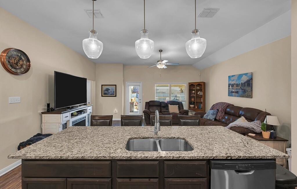 4101 King Ranch Road Waco, TX 76705 - Photo 11 of 32 a kitchen with granite countertop a sink and a flat screen tv