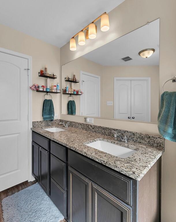 4101 King Ranch Road Waco, TX 76705 - Photo 19 of 32 a kitchen with granite countertop kitchen island sink and refrigerator