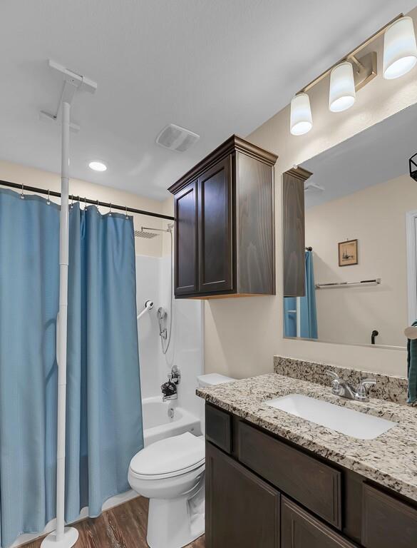 4101 King Ranch Road Waco, TX 76705 - Photo 23 of 32 a bathroom with a granite countertop sink toilet and shower
