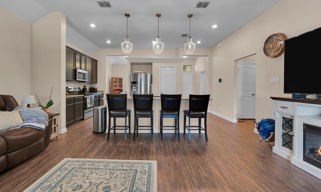 4101 King Ranch Road Waco, TX 76705 - Photo 8 of 32 a large kitchen with furniture and wooden floor