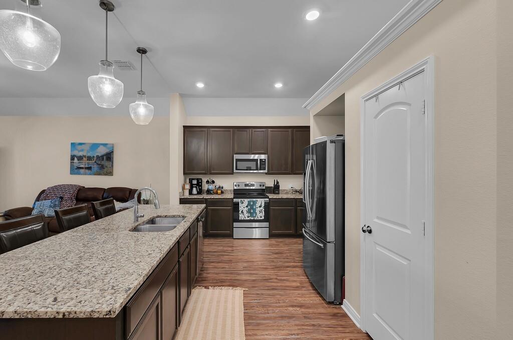 4101 King Ranch Road Waco, TX 76705 - Photo 10 of 32 a kitchen with stainless steel appliances granite countertop a refrigerator a oven a sink dishwasher and a stove with wooden floor