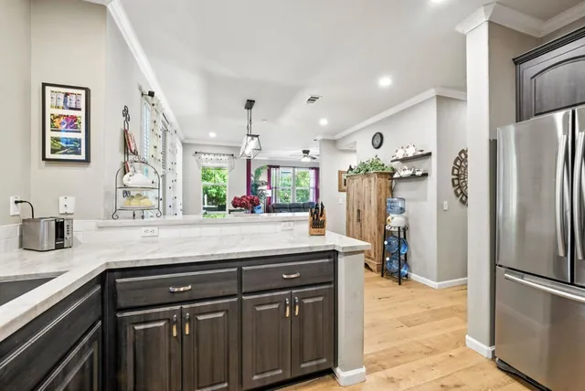 a kitchen with stainless steel appliances granite countertop a refrigerator and a sink