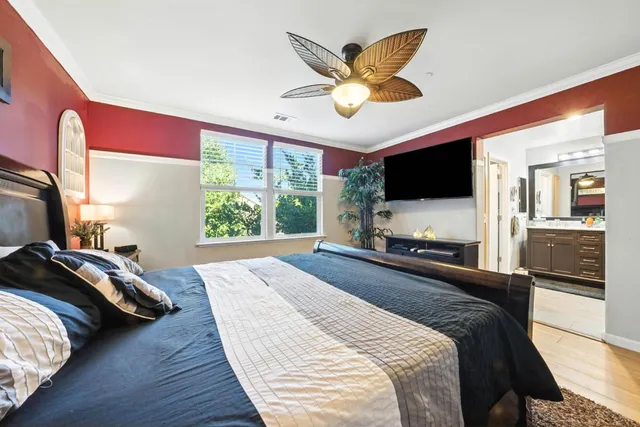 a bedroom with a large bed and a flat screen tv