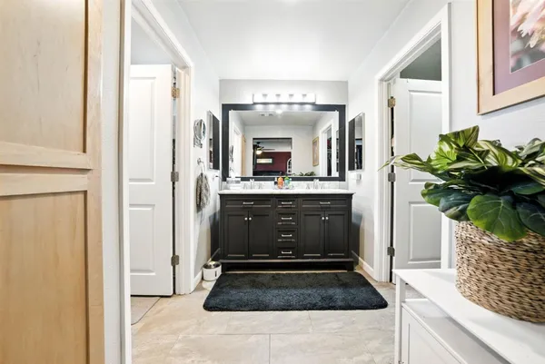 a bathroom with a granite countertop sink a mirror and a shower