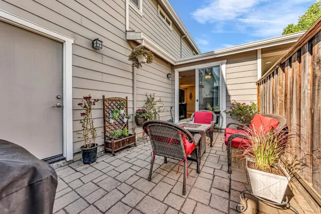 a outdoor sitting area with furniture and wooden floor
