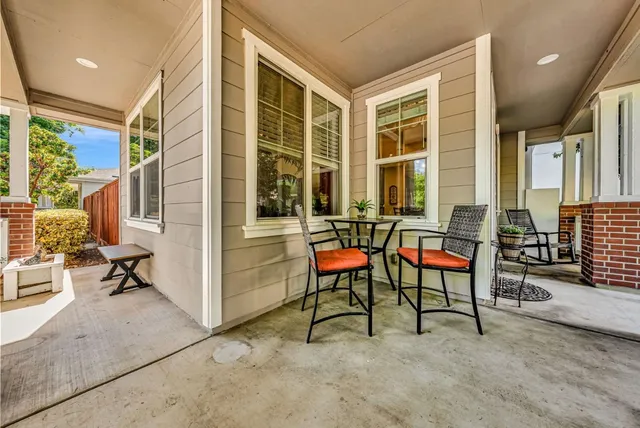 a balcony with table and chairs