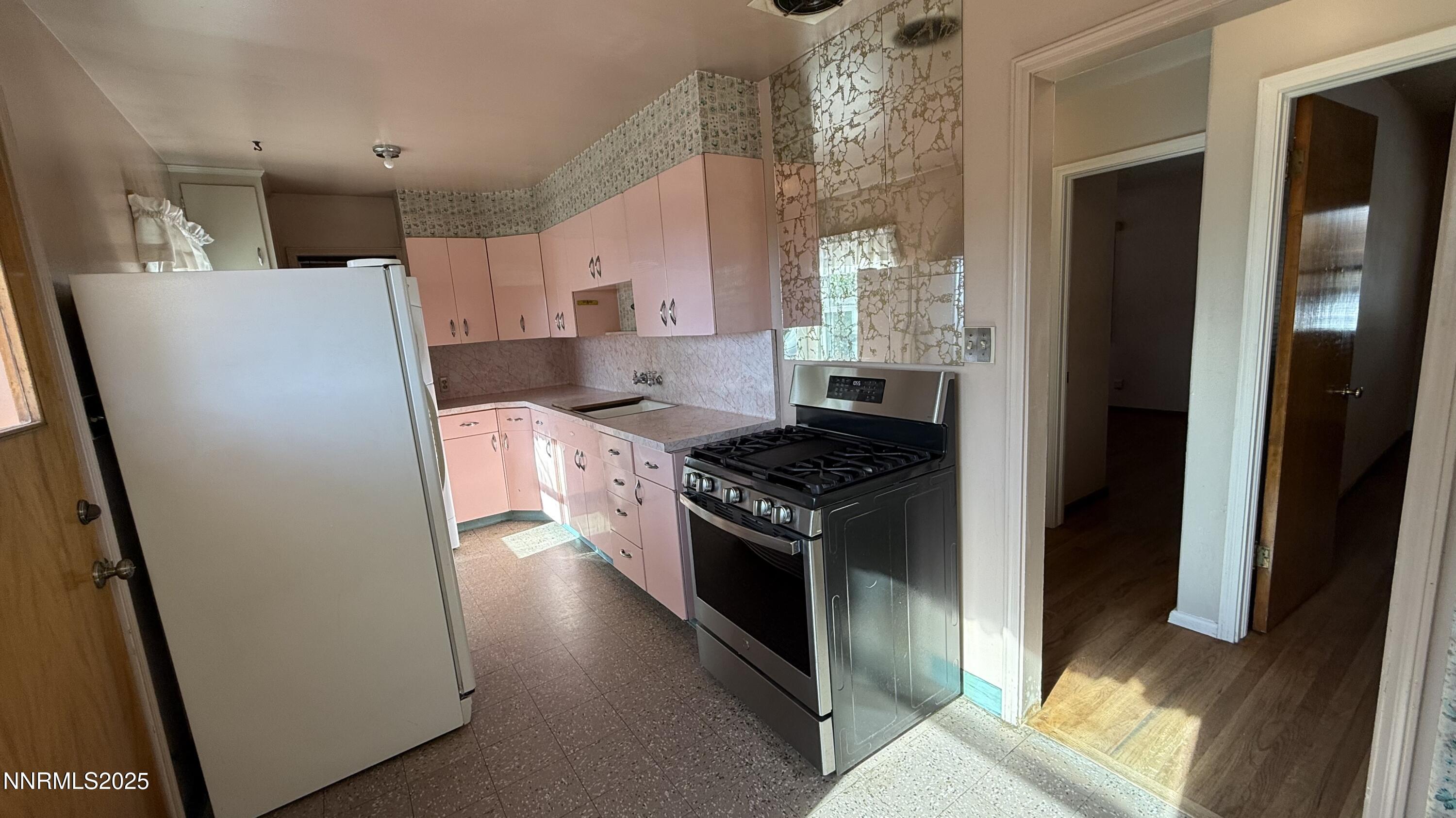 1455 Wesley Drive Reno, NV 89503 - Photo 11 of 27 a kitchen with granite countertop a refrigerator and a stove