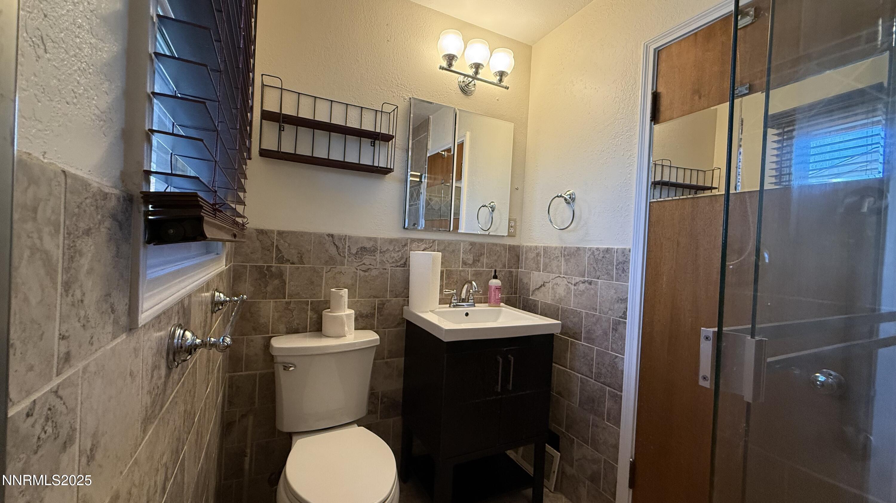 1455 Wesley Drive Reno, NV 89503 - Photo 12 of 27 a bathroom with a sink toilet and a mirror