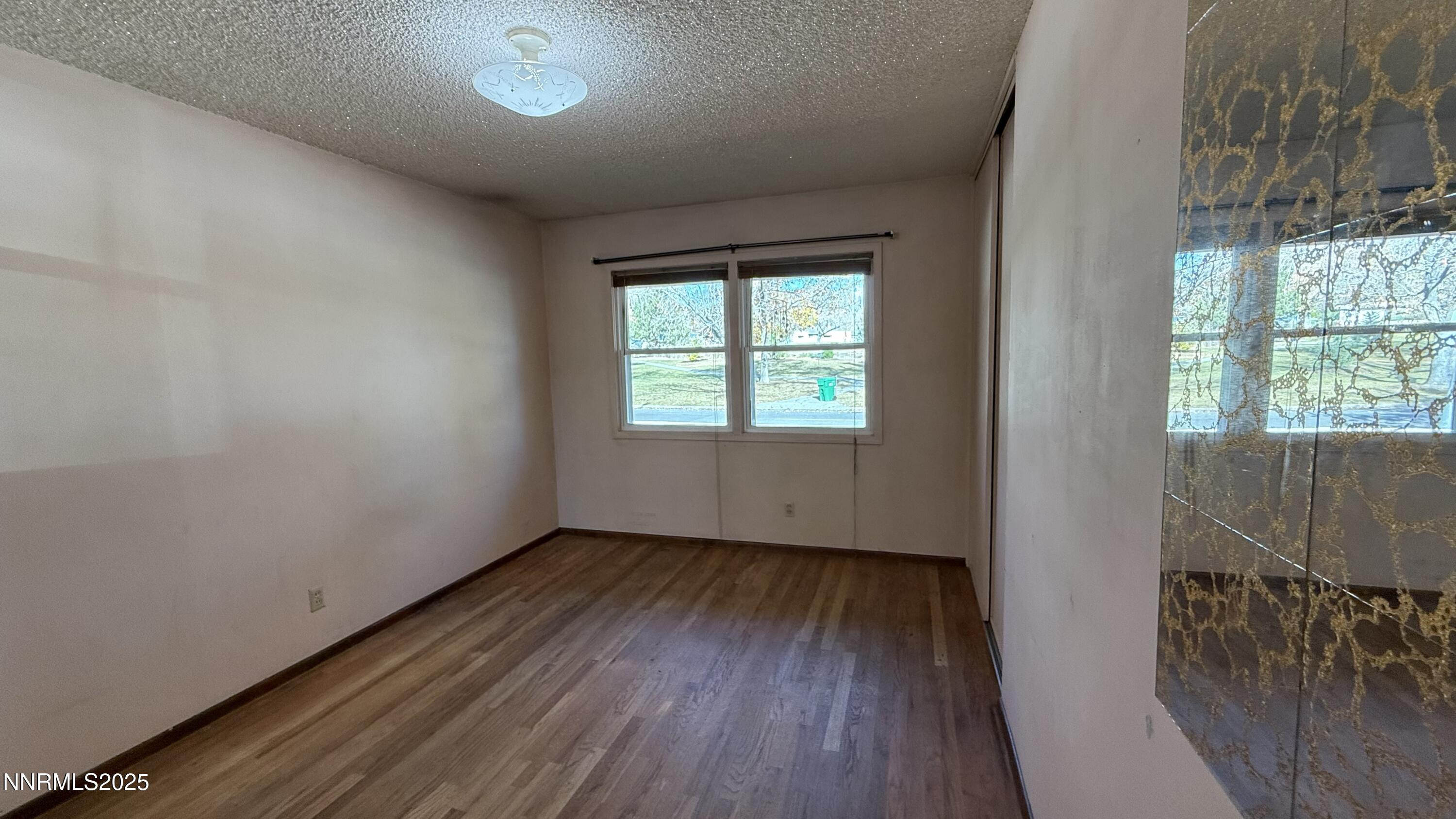 1455 Wesley Drive Reno, NV 89503 - Photo 16 of 27 an empty room with wooden floor and windows