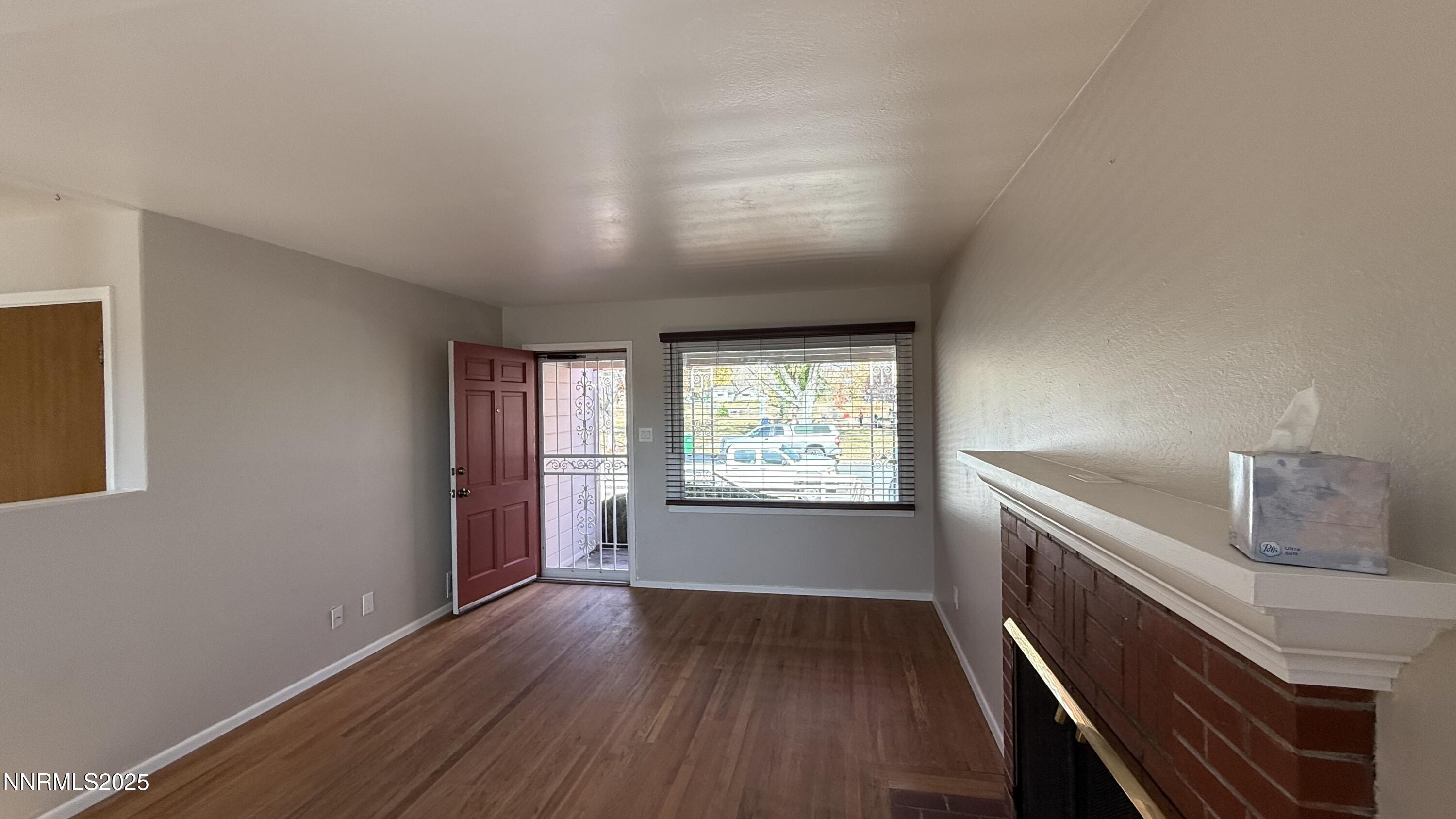 1455 Wesley Drive Reno, NV 89503 - Photo 5 of 27 a view of an empty room with wooden floor and a window