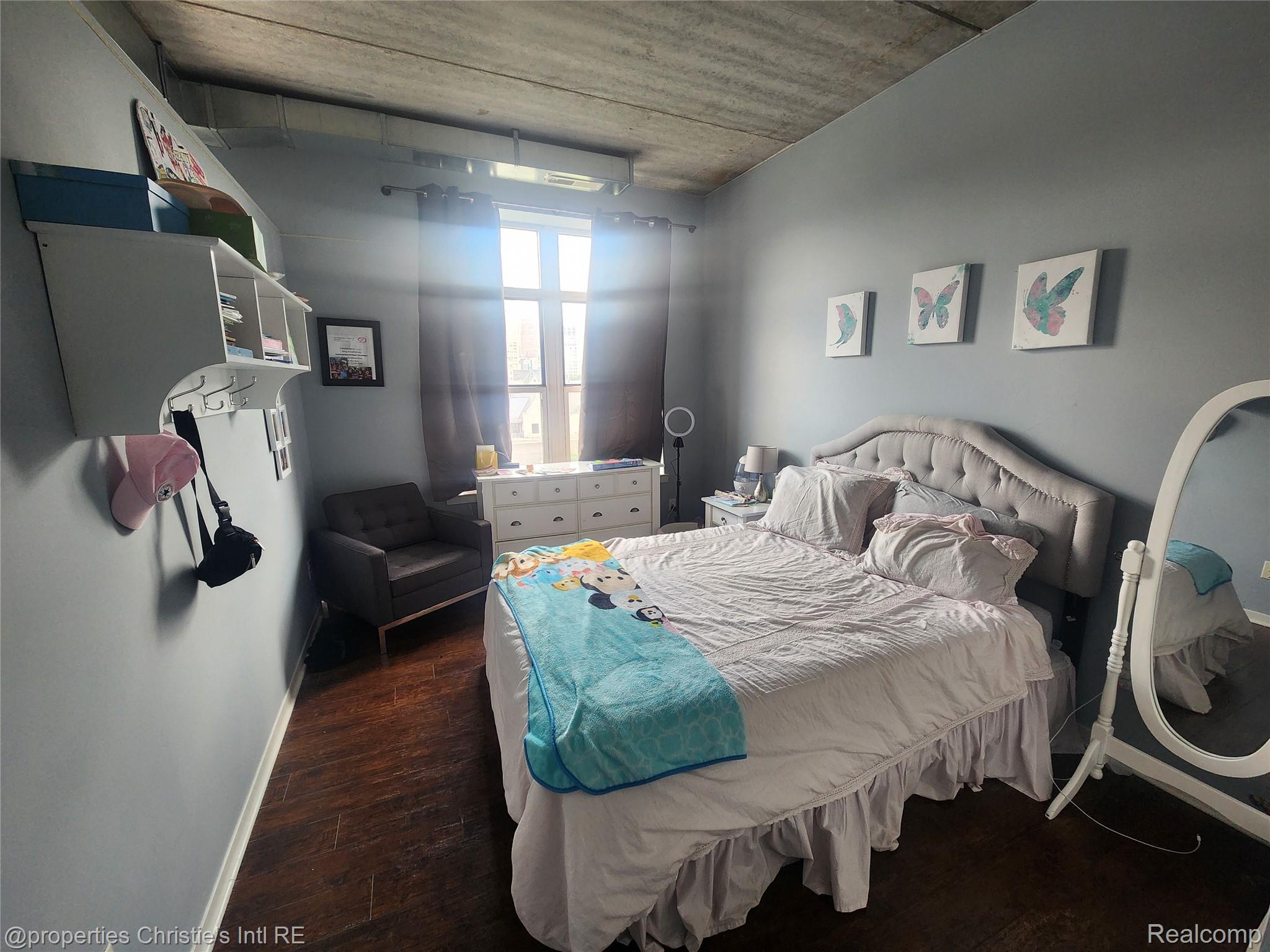 66 Winder Street, Unit 458 Detroit, MI 48201 - Photo 9 of 19 Bedroom with dark wood-style floors and baseboards