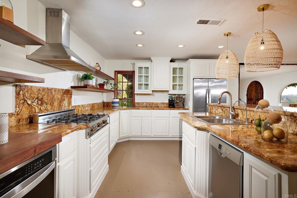 3182 Lone Jack Road Encinitas, CA 92024 - Photo 15 of 37 a kitchen with stainless steel appliances granite countertop a sink stove and refrigerator