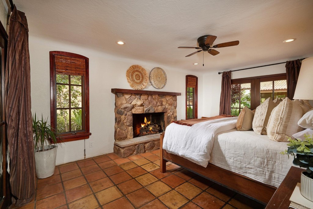 3182 Lone Jack Road Encinitas, CA 92024 - Photo 21 of 37 a bedroom with a bed and a fireplace