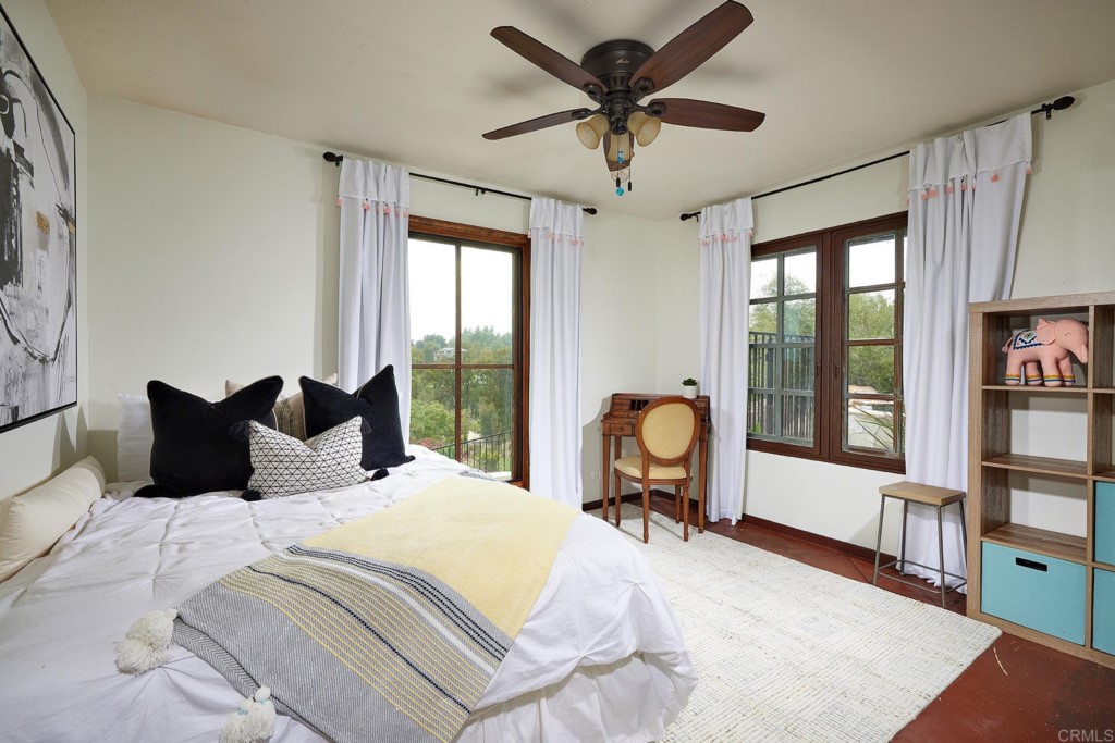 3182 Lone Jack Road Encinitas, CA 92024 - Photo 27 of 37 a bedroom with a bed large window with table and chairs