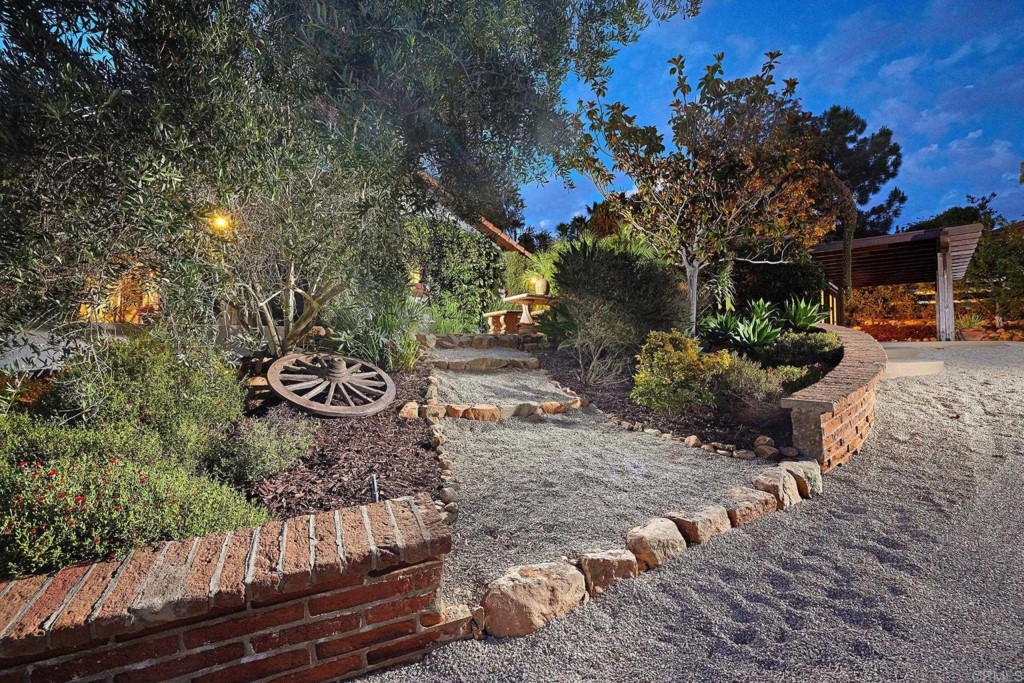 3182 Lone Jack Road Encinitas, CA 92024 - Photo 6 of 37 a view of a back yard of the house and a car parked on the road