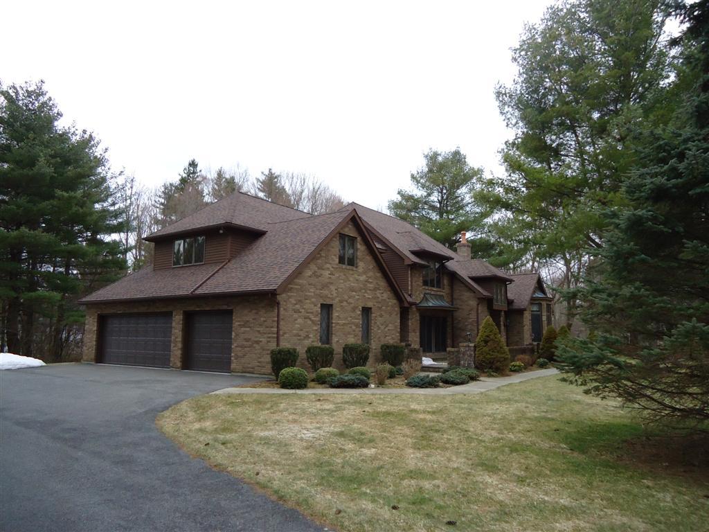16 Prospect Hill Road Stockbridge, MA 01262 - Photo 4 of 25 a front view of a house with a yard and garage