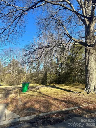 a view of a yard with wooden fence