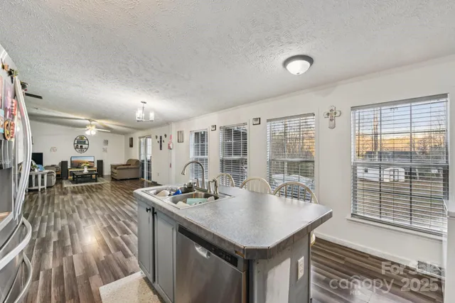 a kitchen with a table chairs and wooden floor