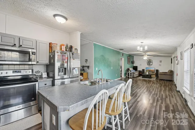 a kitchen with sink refrigerator and cabinets